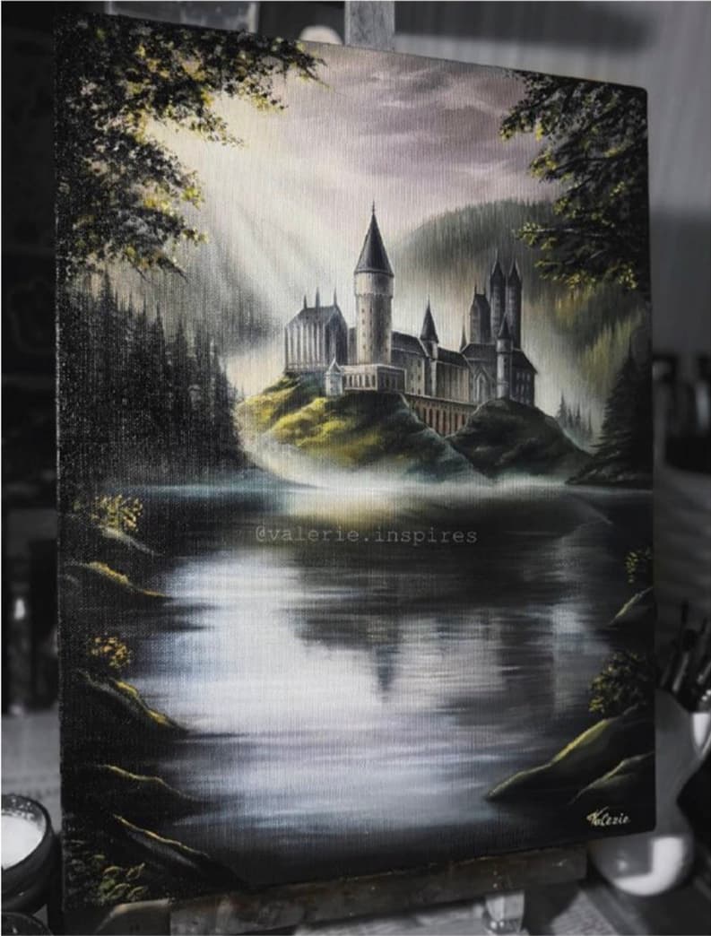 Oil painting of a castle above a misty lake, framed by shadowed trees.