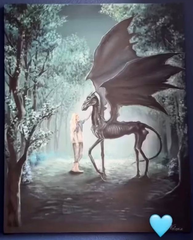 A commissioned painting of a girl with a dark winged creature in a luminous forest, displayed on a blue wall.
